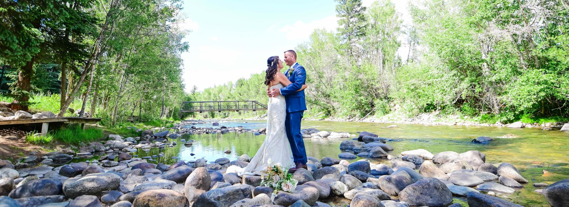 bride and groom by river